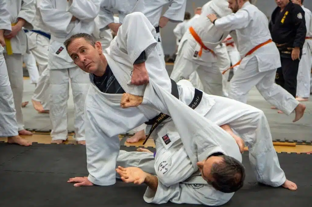 Black belt student throwing a training partner during a TJK jujutsu seminar