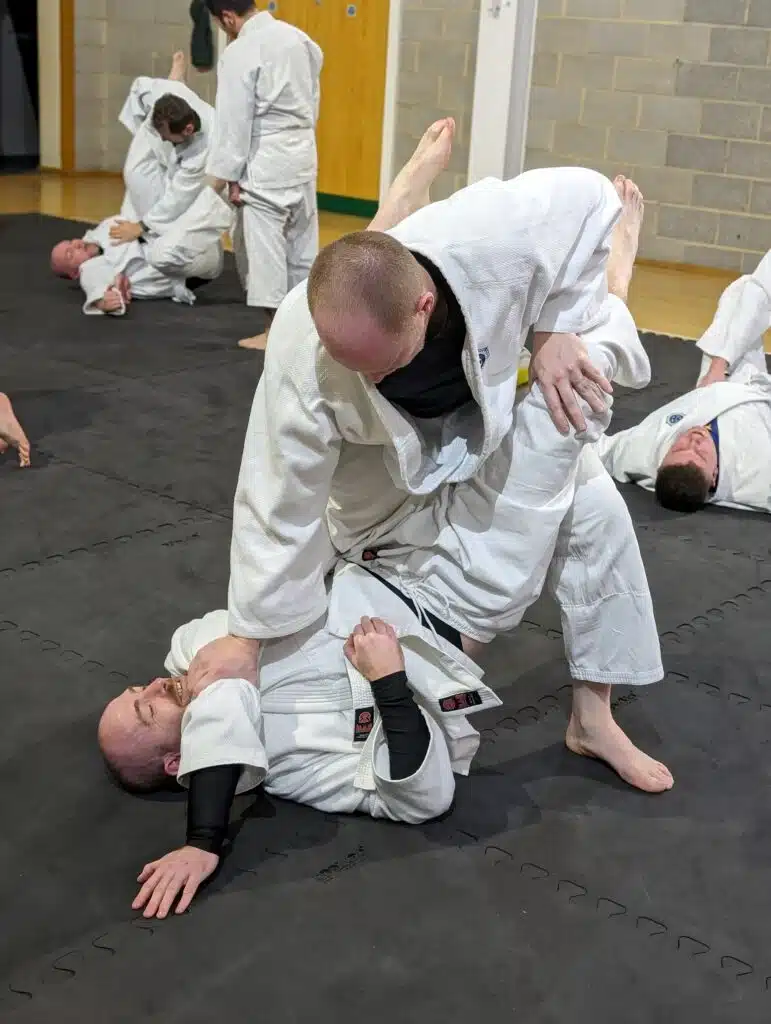 Student controlling a partner from top position during groundwork practice